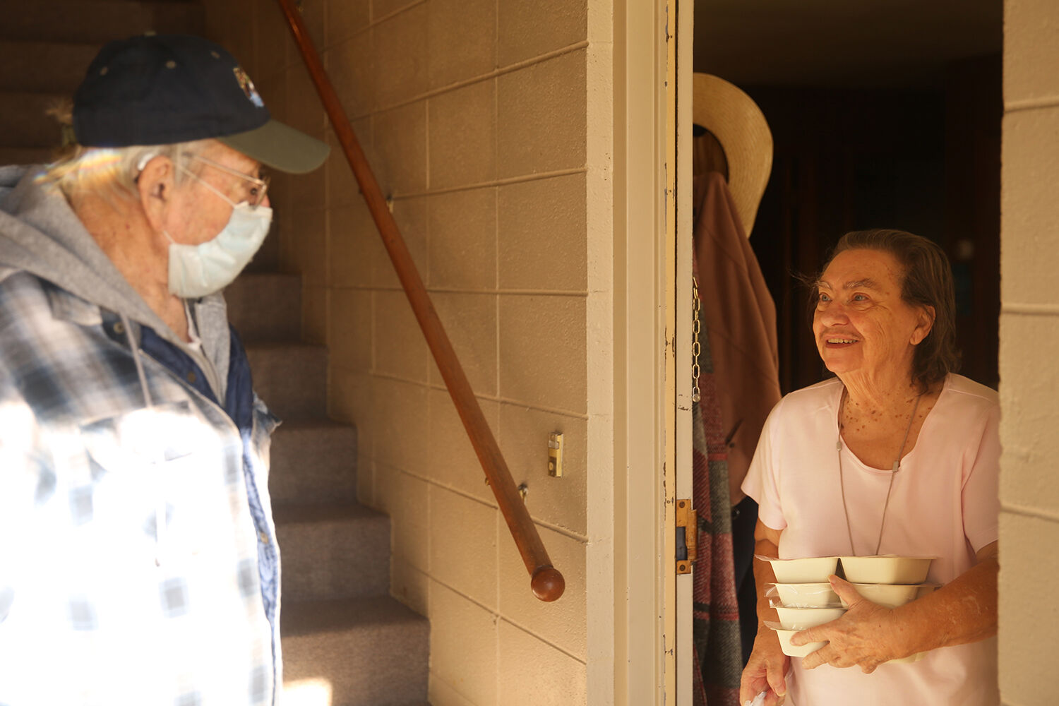 Jean Russell, right, laughs with Leo Sampson after receiving her food